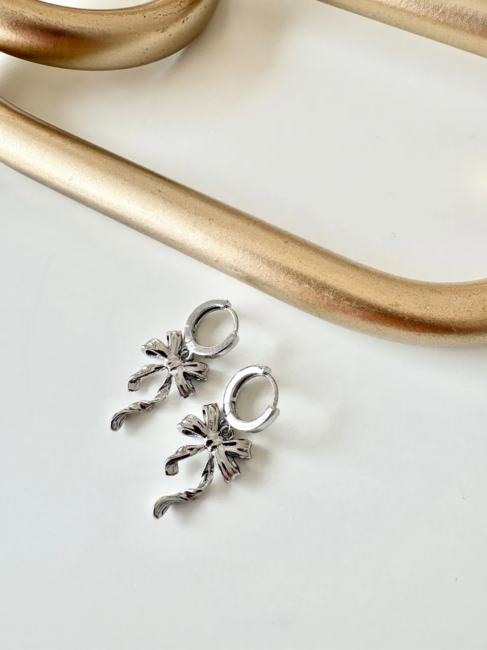 Silver Bow Huggie Earrings — handmade by Dirty Bird Jewellery